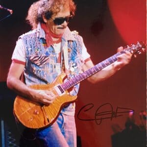 Guitarist performing on stage with electric guitar.