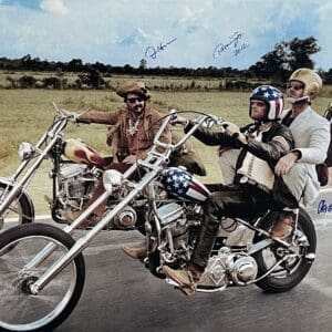 Three men riding motorcycles on an open road.