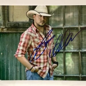 Cowboy hat, plaid shirt, autograph on photo.