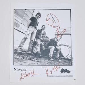 Signed Nirvana band photo with three members.