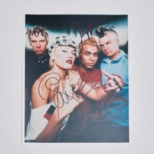 Autographed photo of a four-member band.