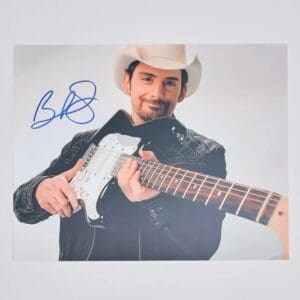 Man in cowboy hat holding electric guitar.