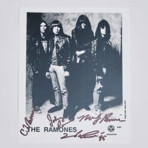 Band members in leather jackets, signed photo.