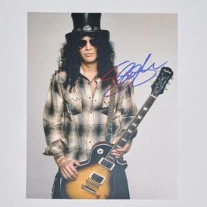 Musician with guitar and top hat posing.