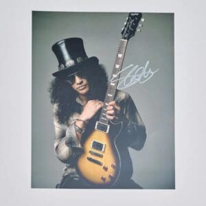 Guitarist with hat holding electric guitar.