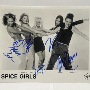 Group of women posing, signed Spice Girls photo.