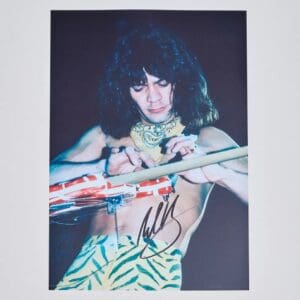 Musician playing guitar with zebra-patterned pants.