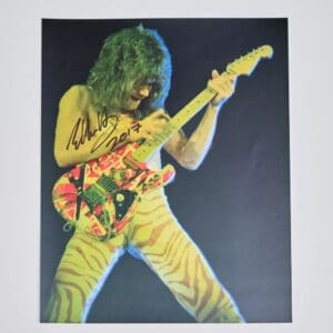 Guitarist performing with colorful electric guitar.