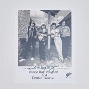 Band photo of four musicians posing.