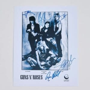 Band members posing with autographs on photo.