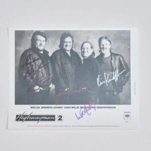 Black-and-white photo of four smiling men.