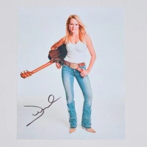 Woman with guitar and autograph on photo.