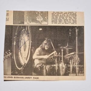 Newspaper clipping of a drummer performing live.