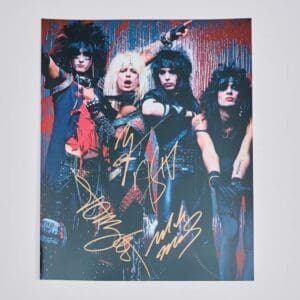 Rock band members with colorful outfits, autographed.