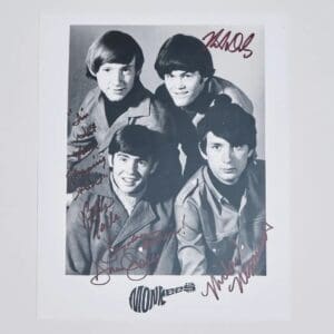 Four men in a signed black-and-white photo.