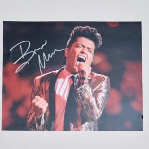 Singer passionately performing on stage, signed photo.