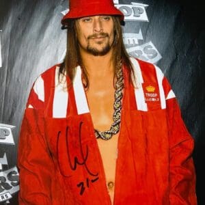 Man in red outfit and hat posing.