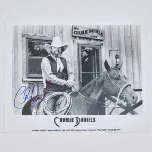 Man on horse outside building with sign.