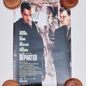 Movie poster with autographs and round objects.