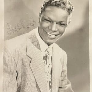 Smiling man in suit with autograph.