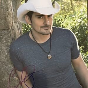 Man wearing cowboy hat near a tree.