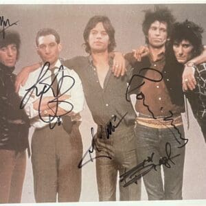 Five people posing with autographs on photo.