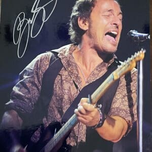 Singer passionately performing on stage with guitar.