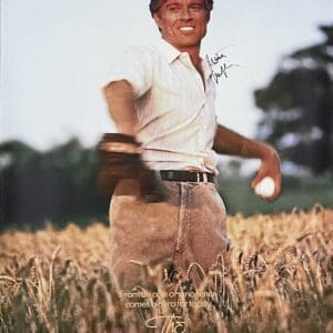 Man in field holding a baseball.