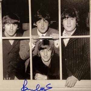 Four men looking through window with autograph.