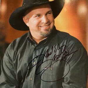 Man in black cowboy hat smiling.