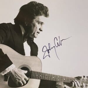 Musician playing guitar, with a signature.