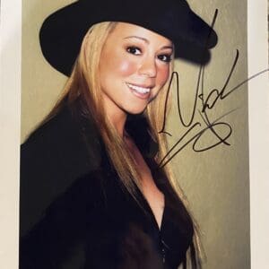 Smiling woman in cowboy hat, autographed photo.