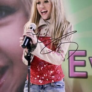 Young woman singing with a microphone.
