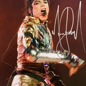 Performer in gold outfit singing energetically on stage.