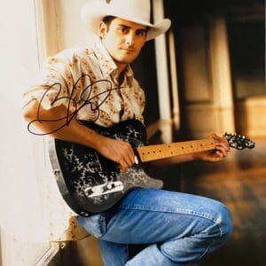 Man in cowboy hat playing electric guitar.