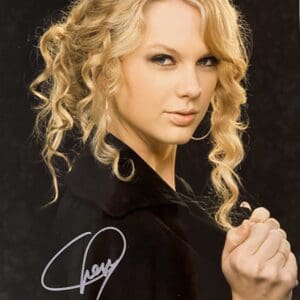 Blonde woman with curly hair, black outfit.