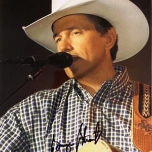 Singer performing in cowboy hat with guitar.