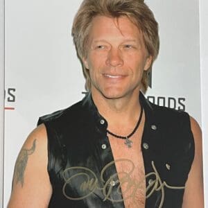 Man in sleeveless black shirt, smiling.