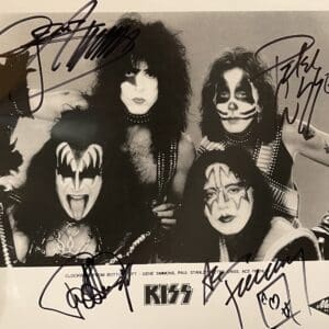 Rock band members in makeup, signed photo.