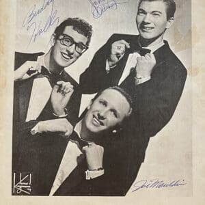 Three men in suits adjusting bow ties.