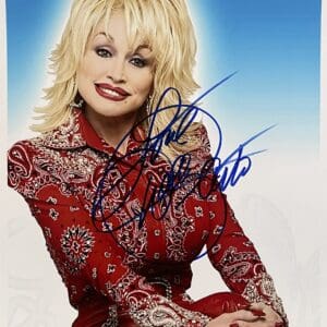 Woman in red outfit, smiling, with autograph.