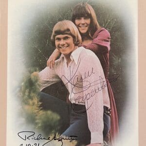 Two people smiling in a vintage portrait.