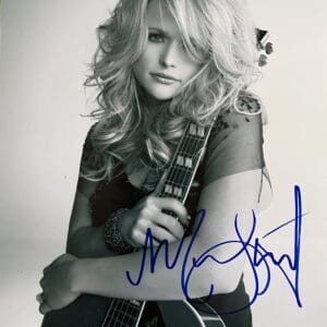Person holding guitar, black and white photo.