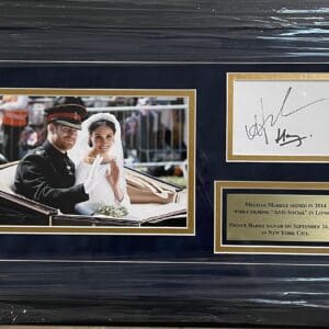 Framed wedding photo with autographs and plaque.