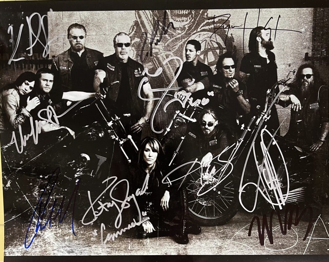 Group of people with motorcycles, autographed photo.