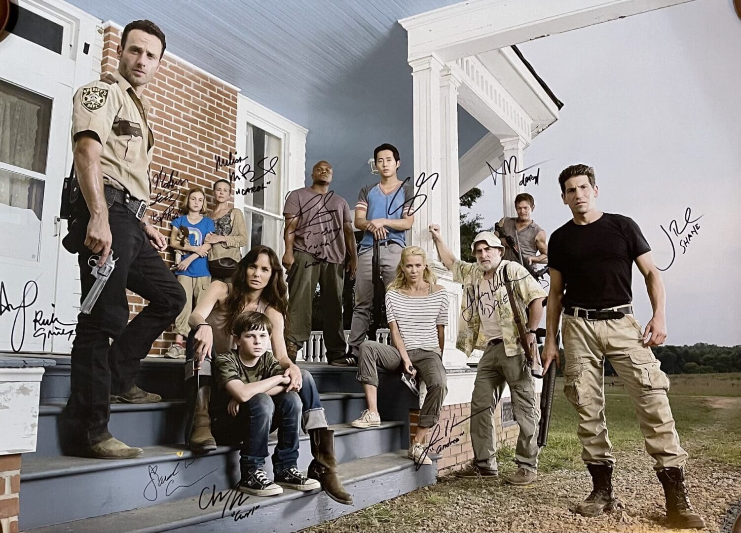 Group of people posing on porch steps.