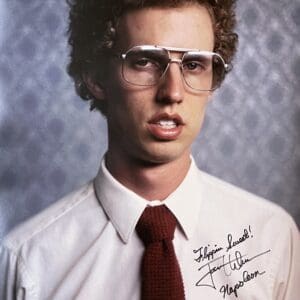 Young man with curly hair, wearing glasses.