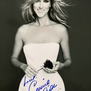 Woman in strapless dress holding a rose.