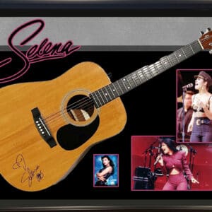 Autographed guitar with singer's performance photos.