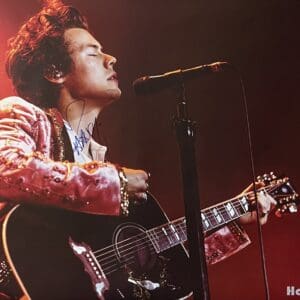 Singer performing passionately with a guitar.
